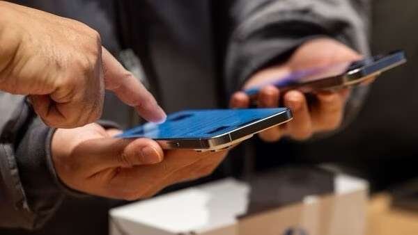 A customer look at an iPhone 15 smartphone at the new Apple Inc. store inside the Starfield mall during its opening in Hanam, South Korea, on Saturday, Dec. 9, 2023. Apple was due to open another store in the country simultaneously, but it now appears that one is running behind. Photographer: SeongJoon Cho/Bloomberg